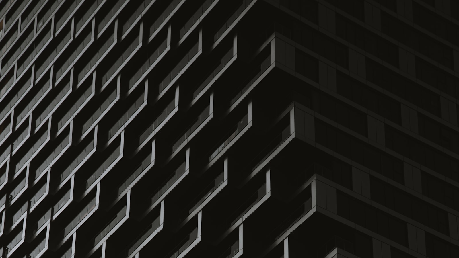 A dark tower facade of identical repeating balconies